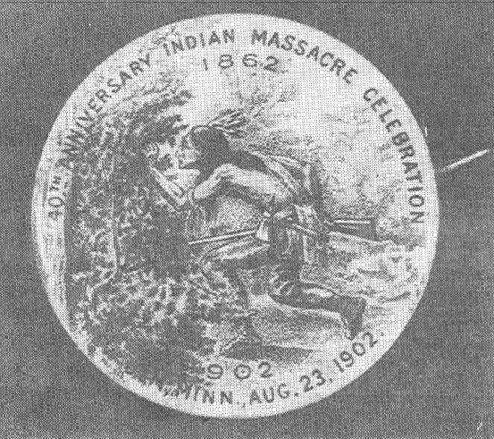 A grainy image of a button, depicting a Dakota warrior sneaking through bushes, with the text: '40th Anniversary Indian Massacre Celebration; 1862; 1902; New Ulm, Minn., Aug. 23, 1902.'